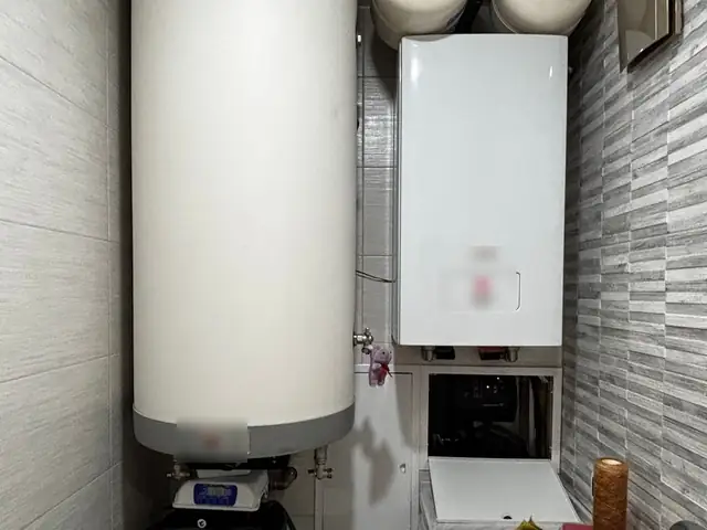 Wall-mounted high-efficiency gas furnace and water heater in a utility room
